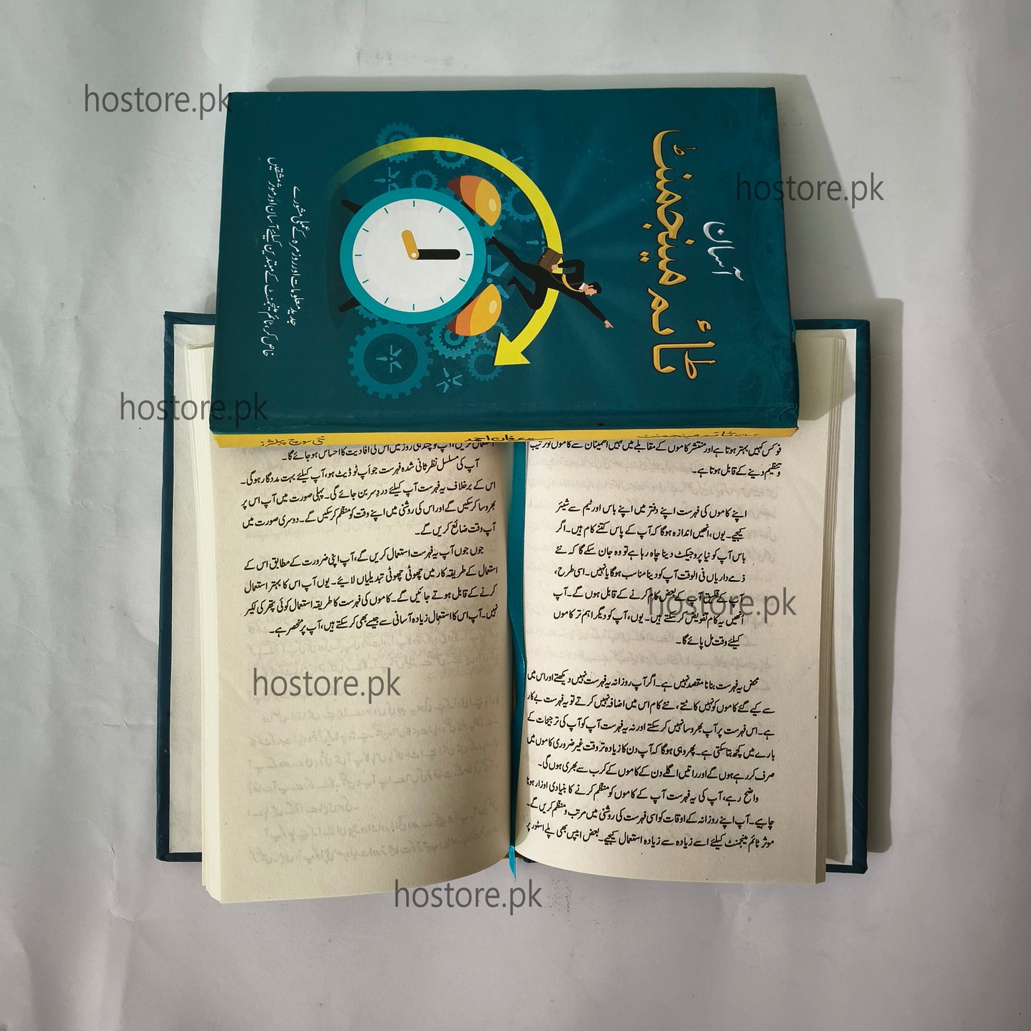 Open book with a decorative cover featuring a clock design and text on a white background.