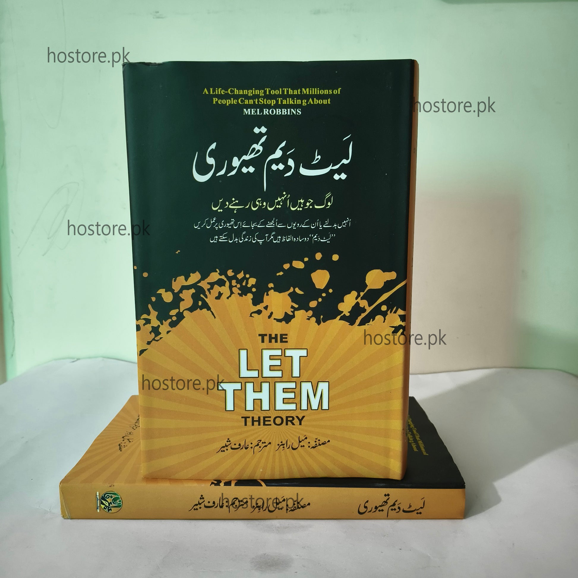 Book titled 'The Let Them Theory' with a black and yellow cover on a white surface.